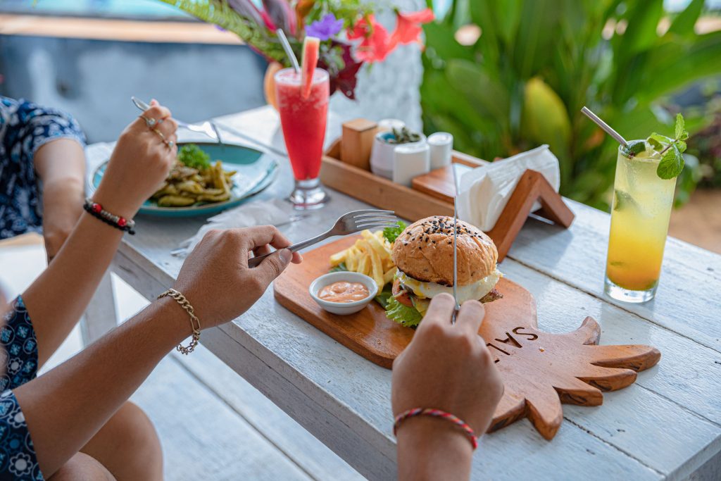 Guests enjoying lunch and tropical drinks at SALT Kitchen & Bar in Amed