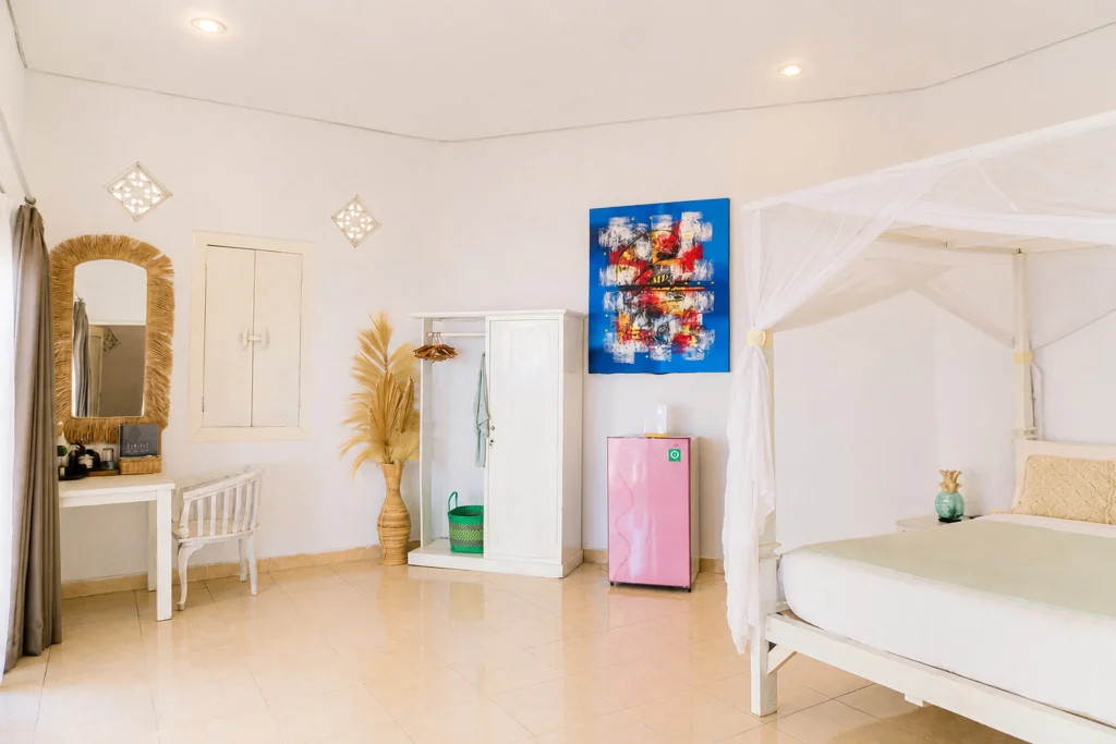 Budget beachfront room desk and bed at Little SALT