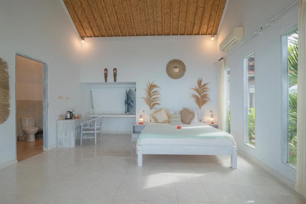 Beachfront suite bedroom and desk wide at SALT Bali
