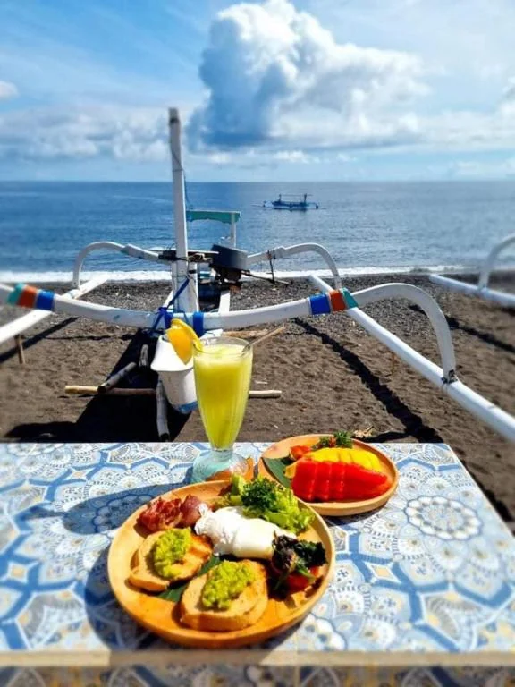 Beachfront suite breakfast by the sea at SALT Bali