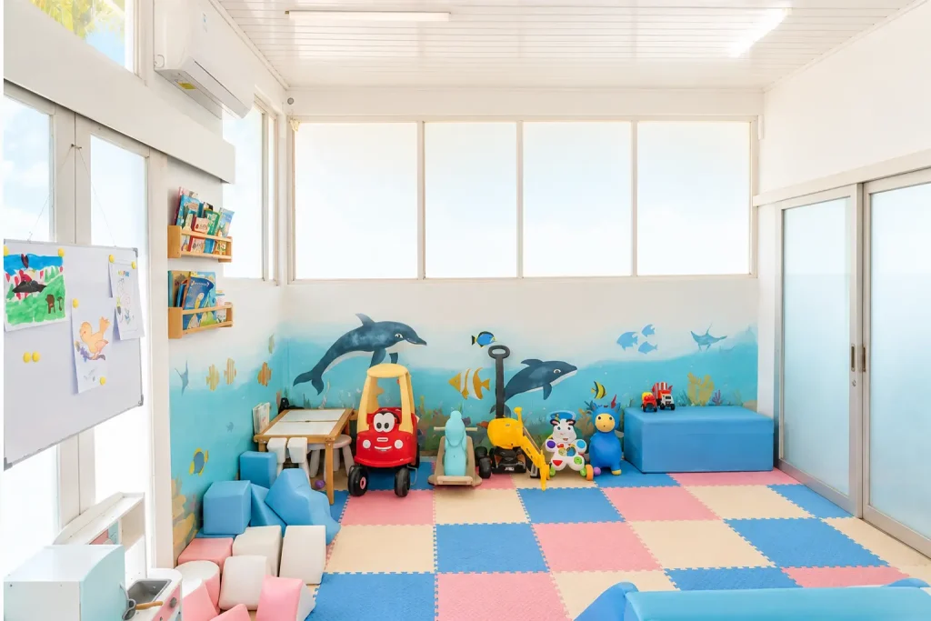 Wide view of Salty Monkeys Kids Club showing colourful play mats, toys and the indoor play space