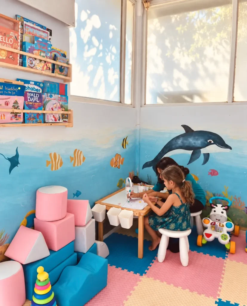 Young child playing inside the colourful Salty Monkeys Kids Club at SALT Bali