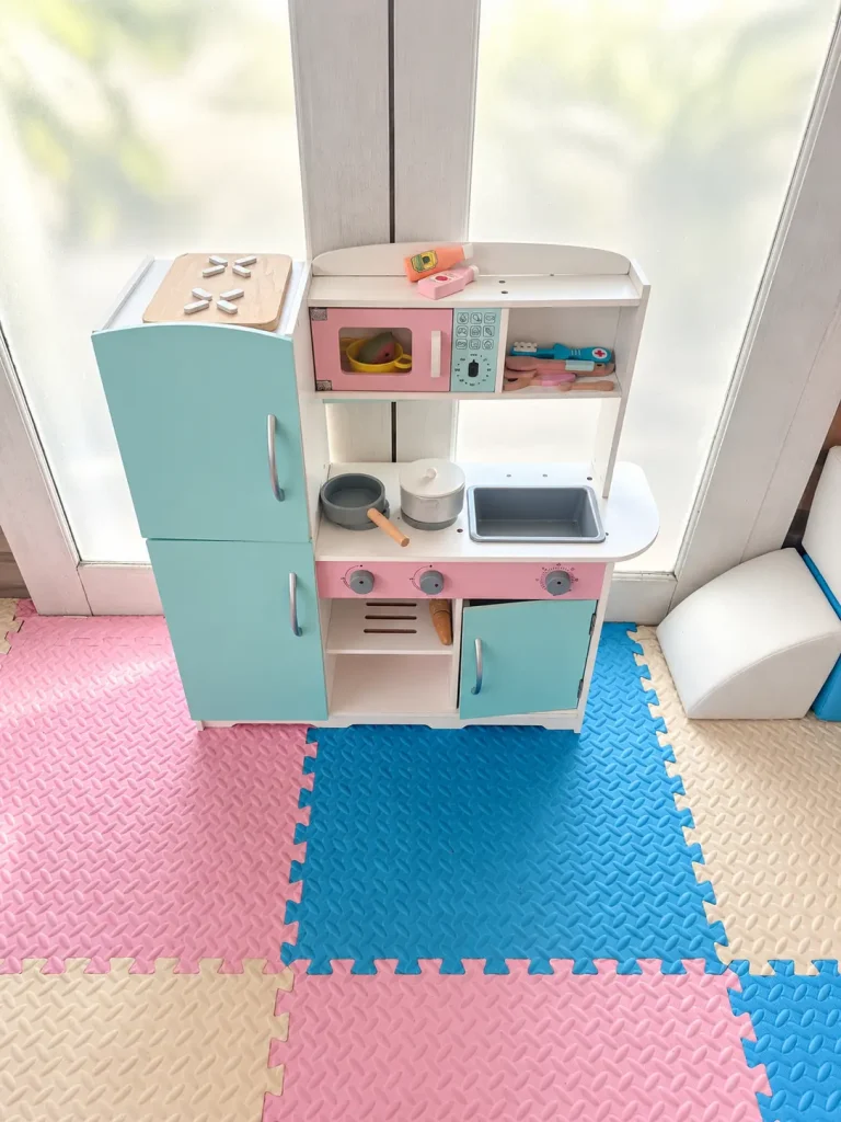 Children's play kitchen, toys and storage shelves at Salty Monkeys Kids Club in Amed, Bali