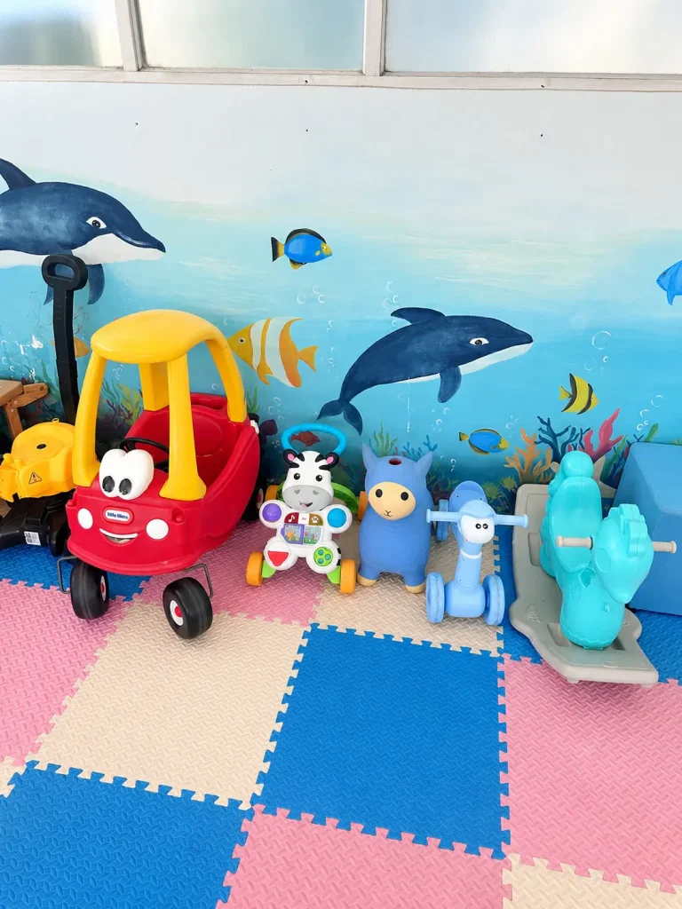 Colourful underwater-themed wall mural and children's toys at Salty Monkeys Kids Club